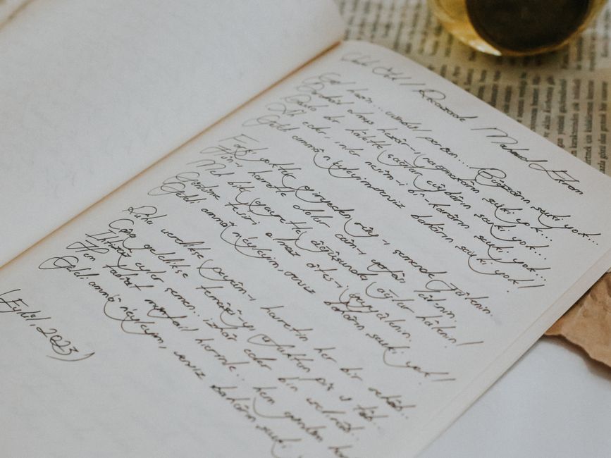 Close-up of elegant handwriting on an open notebook with a vintage aesthetic.